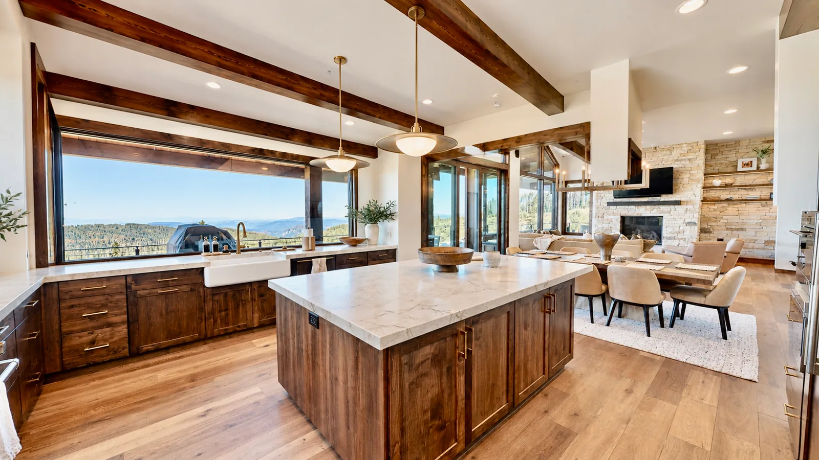 Knotty alder kitchen with marble island and mountain views, custom cabinetry by Cozzens Cabinets