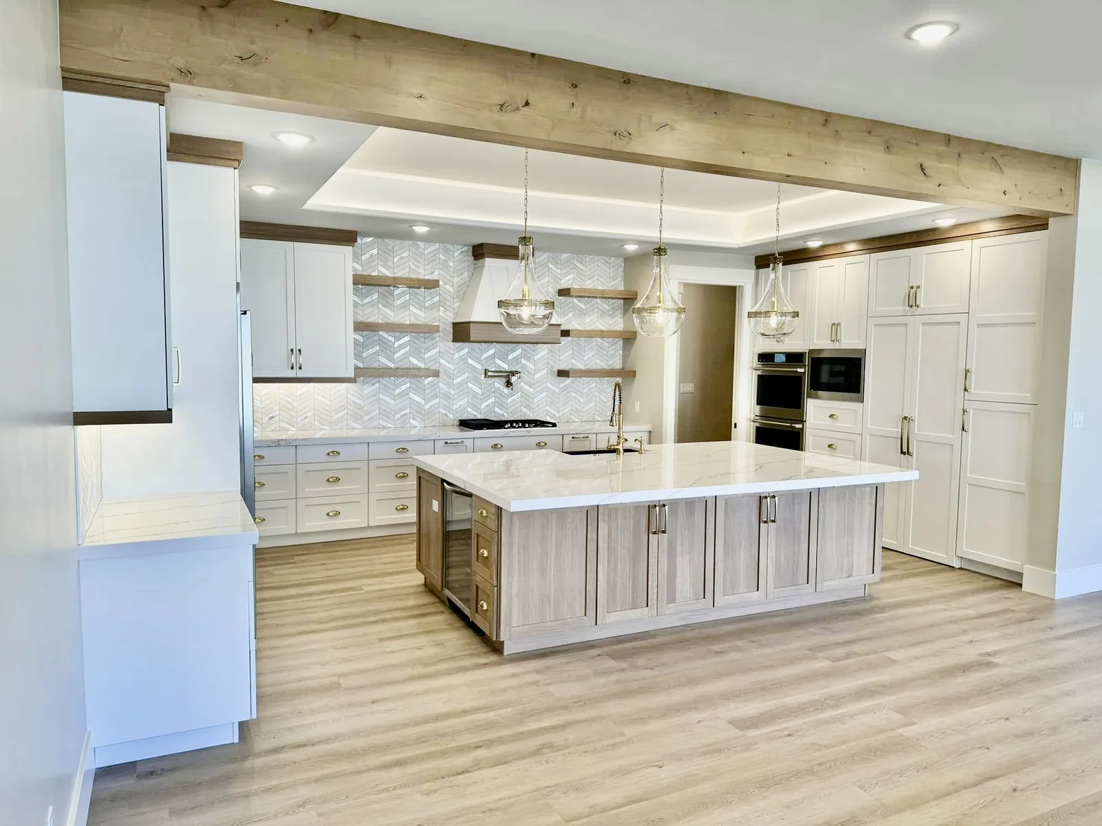 White painted kitchen with rift-oak island and exposed beams